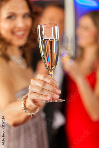 Photo: People with champagne in a bar People with champagne in a bar
