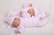 identical twin girls sleeping on a sofa
