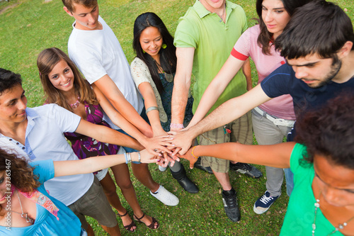 Photo: Happy Teenage Group with Hands on Stack Happy Teenage Group with Hands on Stack