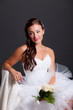 Beautiful dark haired woman in white bridal dress