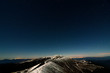 Glittering stars above snowy autumn mountain ridge Glittering stars above snowy autumn mountain ridge