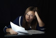 The amazed young woman wearing glasses, sitting at a table among