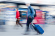 Foto: Motion blured people rushing on airport Motion blured people rushing on airport