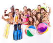 Group people holding beach accessories.