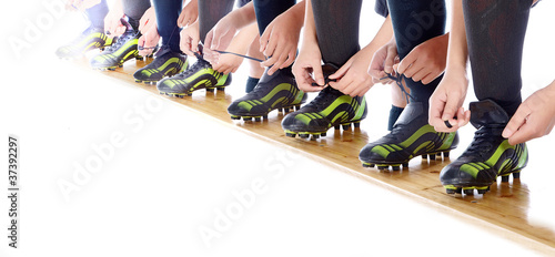 Photo: girls tying up their soccer shoes girls tying up their soccer shoes