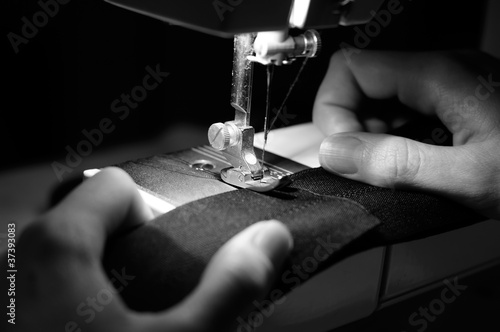Photo: Hands of Seamstress Using Sewing Machine Hands of Seamstress Using Sewing Machine