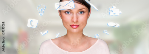 Photo: A business woman with icons of her affairs floating around her A business woman with icons of her affairs floating around her