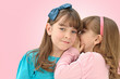 little girls telling secrets