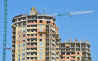 Image : Crane and building construction site against blue sky