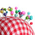 Colored pinheads in pin-cushion isolated on white