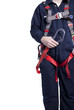 man wearing coveralls and fall protection harness and lanyard