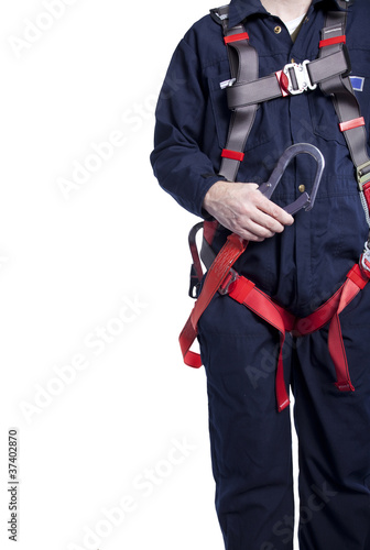 Photo: man wearing coveralls and fall protection harness and lanyard man wearing coveralls and fall protection harness and lanyard