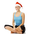 Fitness woman wearing Santa's hat