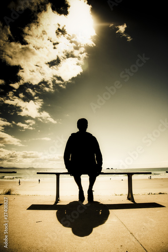 Photo: Young Man In Silhouette Sitting In The Sun Young Man In Silhouette Sitting In The Sun