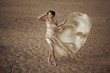 Woman in flying gold cloth