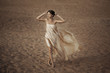 Woman in flying gold cloth