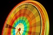 Foto: Amusement park at night - ferris wheel in motion Amusement park at night - ferris wheel in motion