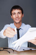 Handsome business man giving us to sign documents with pen
