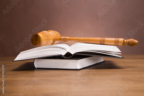 Photo: Scales of justice and gavel on desk with dark background Scales of justice and gavel on desk with dark background