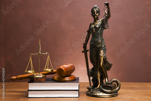 Photo: Gavel of justice and gavel on desk with dark background Gavel of justice and gavel on desk with dark background