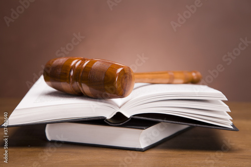 Photo: Gavel of justice and gavel on desk with dark background Gavel of justice and gavel on desk with dark background
