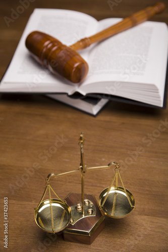 Photo: Scales of justice and gavel on desk with dark background Scales of justice and gavel on desk with dark background