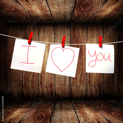 Photo: Note paper hanging on a rope, Love note concept Note paper hanging on a rope, Love note concept