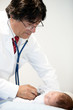 Doctor listening to a baby heart
