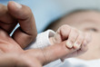 Baby holding a hand