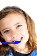 Foto: Girl brushing teeth on white background Girl brushing teeth on white background