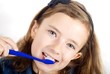 Girl brushing teeth on white background