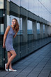 Young woman posing inside a modern top architecture building