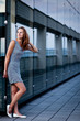 Young woman posing inside a modern top architecture building