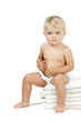 Photo: Baby girl sitting on pile towels Baby girl sitting on pile towels