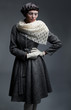 Fashionable woman in grey coat and white scarf