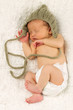 Newborn Baby Sleeping with knitted Hat on.