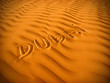Text in desert sand Dubai