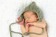 Newborn Baby Sleeping with knitted Hat on.