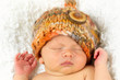 Newborn Baby Sleeping with knitted Hat on.