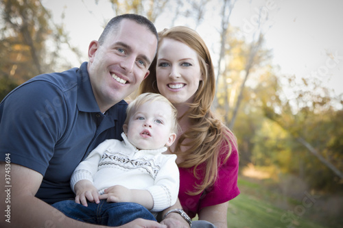 Photo: Young Attractive Parents and Child Portrait Outside Young Attractive Parents and Child Portrait Outside