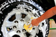 Washing a car tire. With a sponge and shampoo