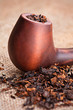Macro of smoking pipe and tobacco on linen canvas background Macro of smoking pipe and tobacco on linen canvas background