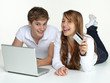 Couple lying on the floor with laptop shopping on the internet