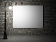 Blank billboard on a brick wall at night.