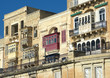 Baroque Facades And Traditional Balconies In Valletta Street