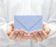 Blue paper envelope in hands