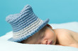Newborn Baby Sleeping with knitted Hat on.