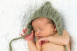 Newborn Baby Sleeping with knitted Hat on.