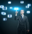Young business man pressing a touchscreen button