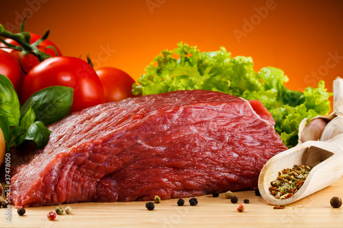 Photo: Raw beef on cutting board and vegetables Raw beef on cutting board and vegetables